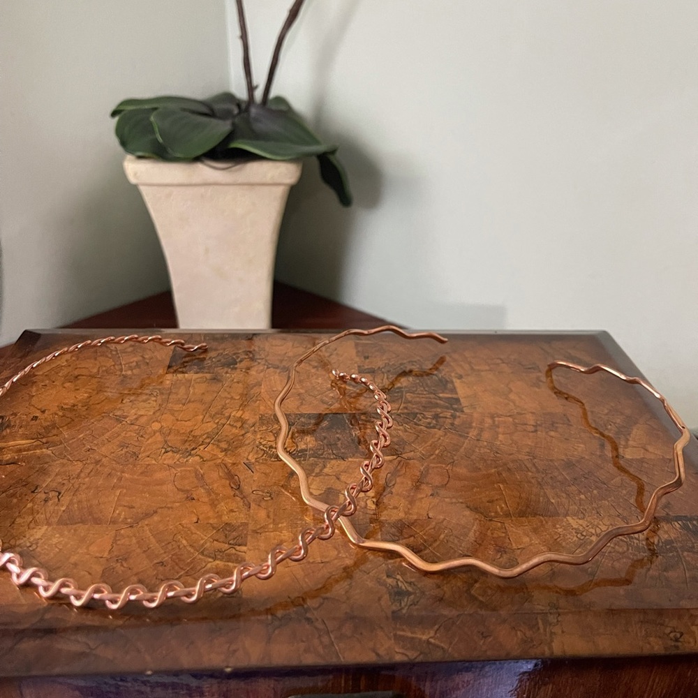 2 copper neck collars. 1 is wavy & 1 wrap around.